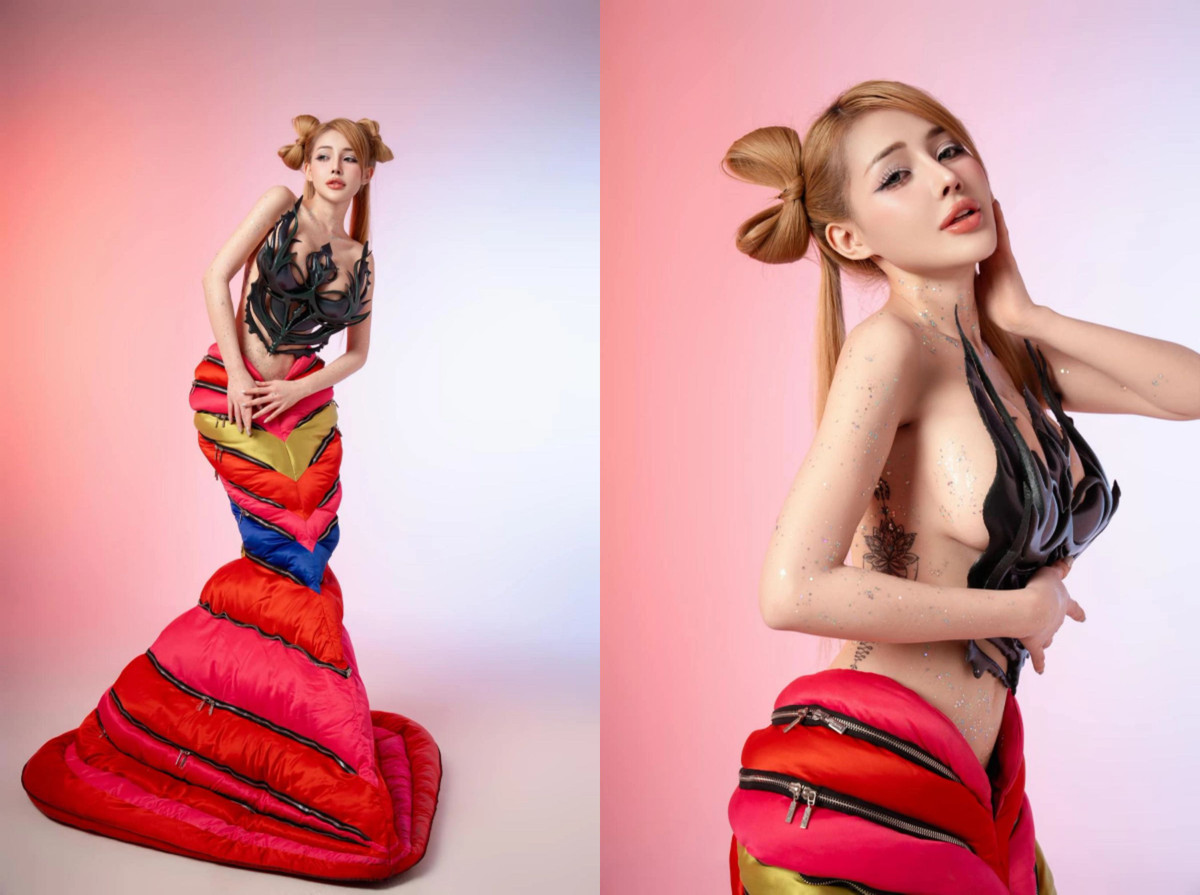 Phần thân dưới lấy cảm hứng từ đuôi cá, được chế tác từ chất liệu phồng giống túi ngủ, phối hợp màu sắc nổi bật như đỏ, hồng, vàng và xanh. Cách sắp xếp lớp vải độc đáo tạo hiệu ứng thị giác ấn tượng, nhấn mạnh đường cong quyến rũ của Ngân 98.