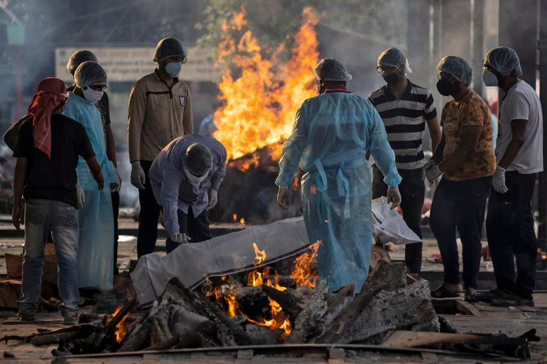 Mọi người chuẩn bị giàn hỏa thiêu cho một người đã tử vong vì COVID-19 tại nhà hỏa táng ở New Delhi ngày 3/6. Mời độc giả xem thêm video: WHO chính thức đặt tên cho virus corona mới là SARS-CoV-2 (Nguồn video: VTC1)
