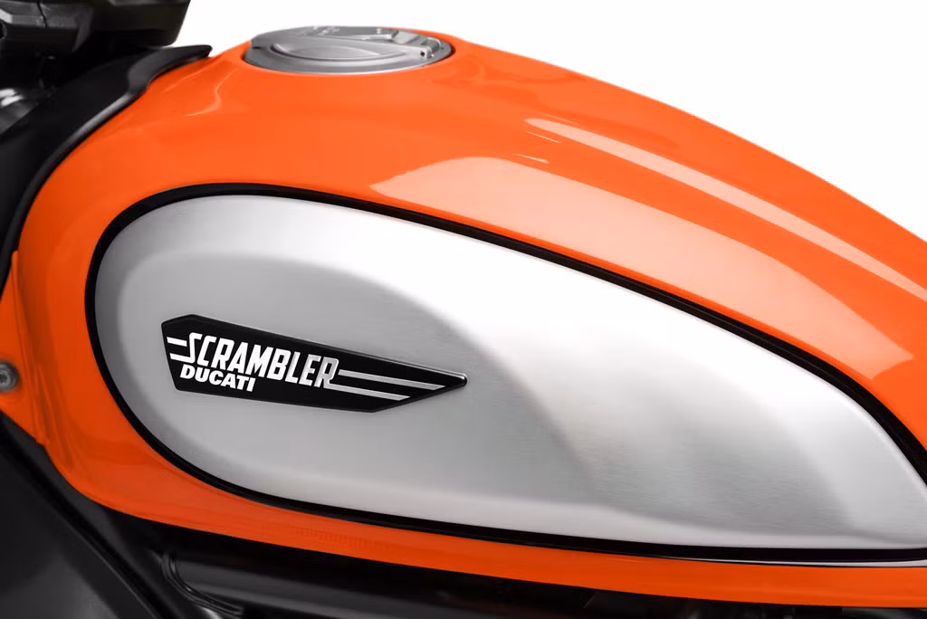 Ốp bình xăng được gò nổi cơ bắp là điểm thừa hưởng từ đàn anh Scrambler 1100. Yên xe cũng được hạ thấp đôi chút và phẳng hơn.