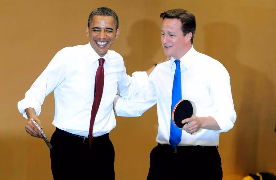 Ông Obama (trái) và Thủ tướng Anh khi đó là ông David Cameron chơi bóng bàn cùng nhau tại Học viện Globe ở London, Anh, ngày 24/5/2011. Ảnh: MSN.