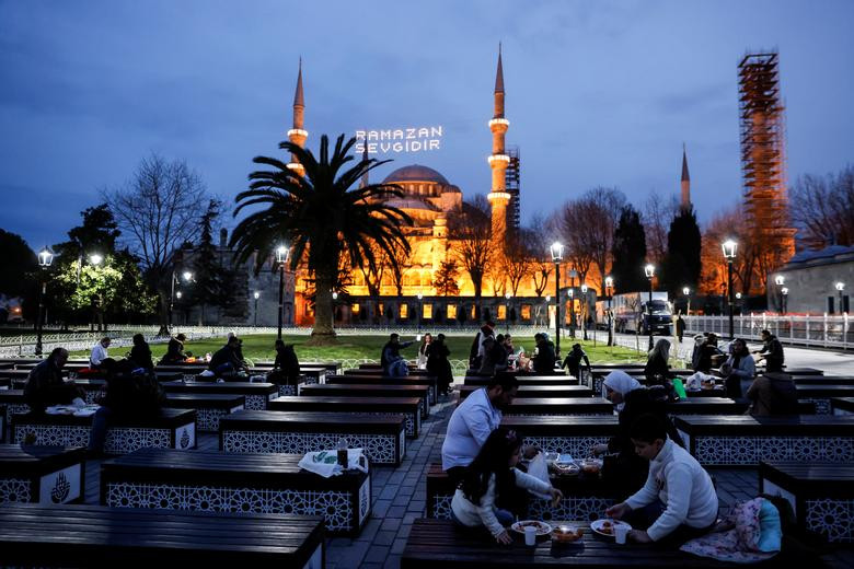 Các tín đồ Hồi giáo ăn bữa Iftar trước nhà thờ Hồi giáo Ottoman-era Sultanahmet ở Istanbul, Thổ Nhĩ Kỳ, ngày 13/4/2021.
