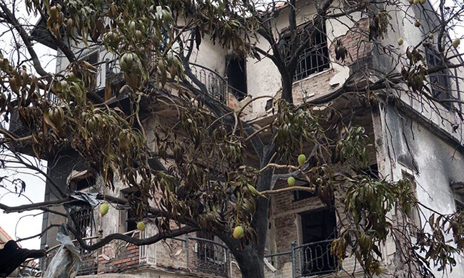 Tại hiện trường cháy cửa hàng chăn ga gối đệm, bên trong và bên ngoài ngôi nhà đều bị "bà hỏa" làm hư hỏng, nhiều mảng tường bị bong tróc, rơi xuống phía dưới.