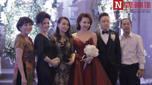 Bạn bè, người thân vui vẻ chụp ảnh lưu niệm cùng cặp đôi.