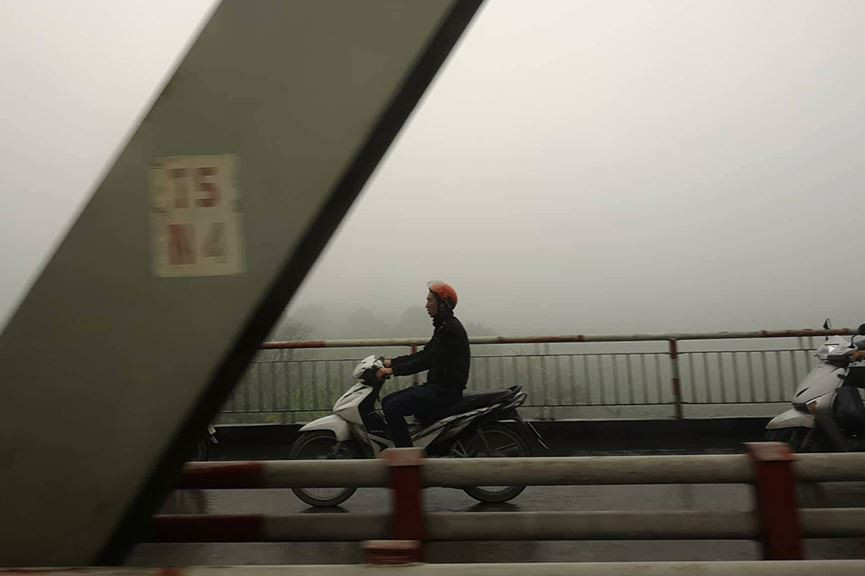 Đi trên cầu Chương Dương không thể nhìn thấy cây cầu Long Biên ngay bên cạnh do sương mù. 