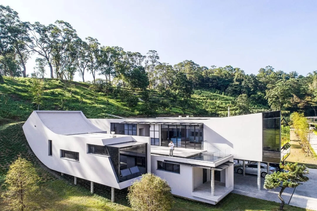 Công trình mang phong cách hiện đại và "không có mái" để gia chủ gần gũi hơn với thiên nhiên yên bình ở đây. Theo đó, ngôi nhà được thiết kế theo bề ngang với các hình khối đơn giản, chia làm 4 phần, sử dụng bê tông cốt thép làm vật liệu chính. Ảnh: Sohu