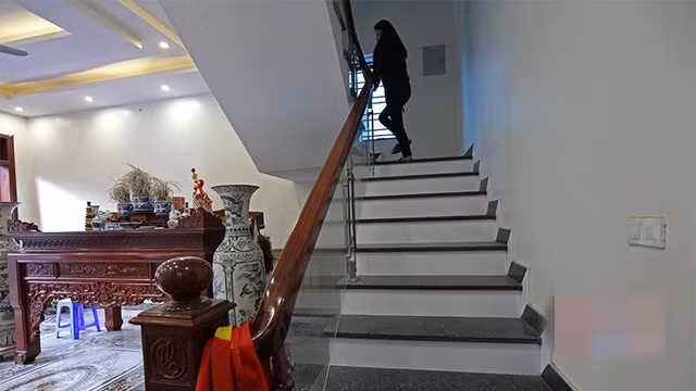 Tay vịn cầu thang dẫn lên tầng 2 bằng gỗ và vách kính. Ảnh: Vietnamnet