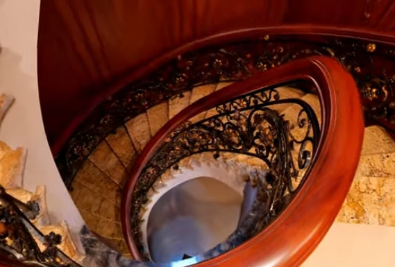 Cầu thang xoắn với lan can bằng sắt mỹ thuật tựa như một giàn hoa hồng leo trong nhà. Ảnh chụp màn hình NhaF