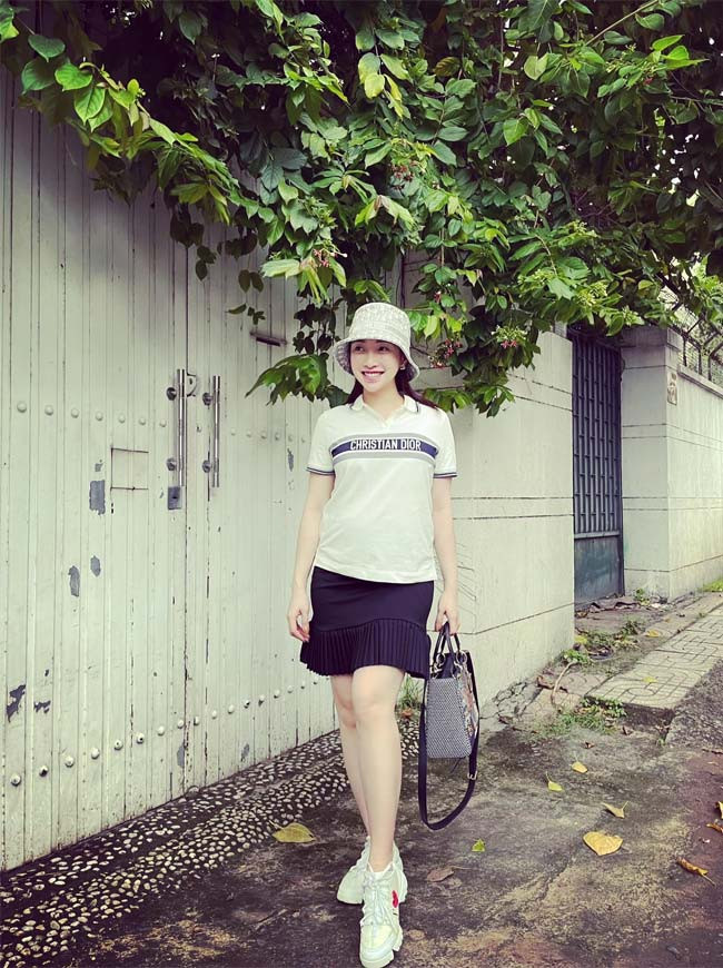 Áo phông trắng, chân váy ngắn hơi xoè, giày thể thao, nếu không có chiếc bụng bầu thì trông Lý Thuỳ Chang trẻ trung không khác gì nữ sinh trung học.