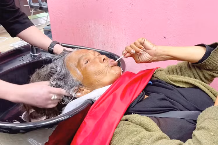 Thúy Nga đã khéo léo dỗ Kim Ngân đi gội đầu, và chủ tiệm phải gội đến 7 lần dầu gội thì tóc của Kim Ngân mới có bọt. Đây cũng là lần đầu nữ ca sĩ chấp nhận để người khác rửa mặt, cắt móng tay cho mình. (Ảnh: Thúy Nga Channel)