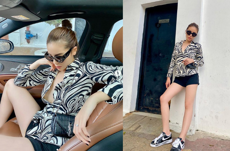 Áo sơ mi họa tiết ngựa vằn kết hợp với quần short đen và đôi giày Air Force 1 x PEACEMINUSONE "Para-noise", trông Kỳ Duyên thật sành điệu.