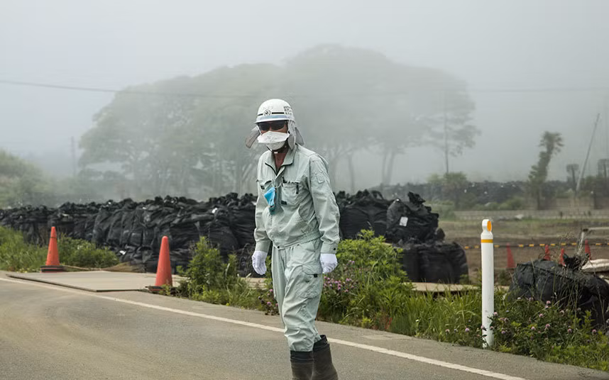 Một công nhân dọn rác phóng xạ tại thị trấn Fukushima.