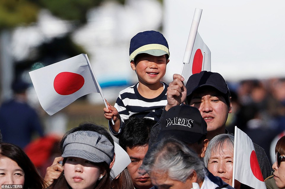 Những người dân Nhật Bản cầm quốc kỳ vui mừng vẫy chào tân Hoàng đế và Hoàng hậu.
