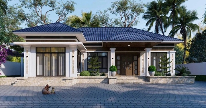 Bố cục ngôi nhà thiết kế hợp lý, phần tường ngoài ốp gạch xám mộc mạc tạo vẻ giản dị và ấm áp. Ảnh: Kientrucphongthuykhanghung