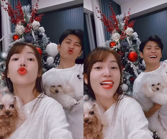 Cặp đôi thích thú chụp hình bên cây thông và cún cưng.