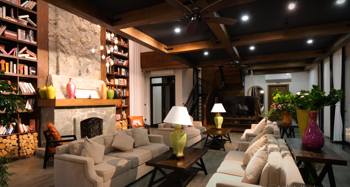 Bên trong phòng khách, trần nhà được gia chủ nắn nót cẩn thận, ánh sáng thiết kế dịu mắt.