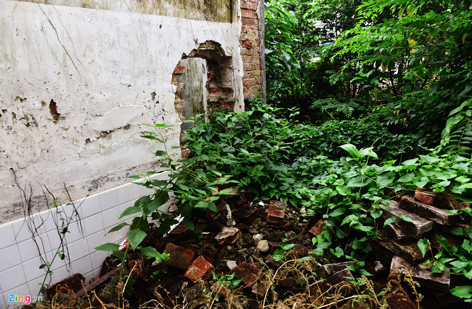 Những bức tường phần phụ phía sau vừa bị đập bỏ hoàn toàn vừa đang đập dở. Những viên gạch được sản xuất gần 100 năm trước bị chất thành đống.