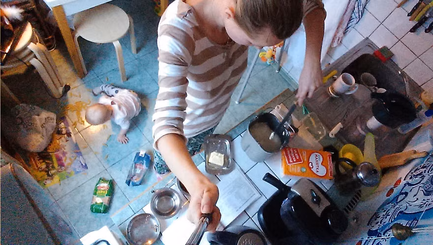 Mẹ thì nấu nướng còn con thì bày bừa dưới sàn nhà bếp. Ảnh: Bored.