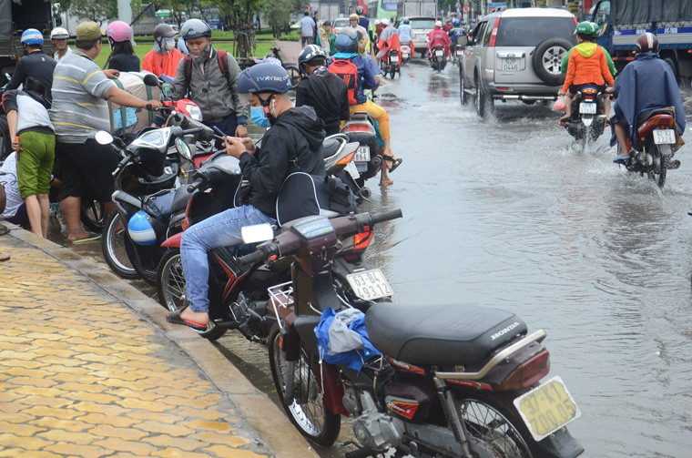 Sáng 26/11, tại khu vực Vòng xoay An Lạc, điểm giao giữa đường Kinh Dương Dương - Quốc lộ 1, còn ngập sâu. Nhiều phương tiện di chuyển qua khu vực bị chết máy hàng loạt. 