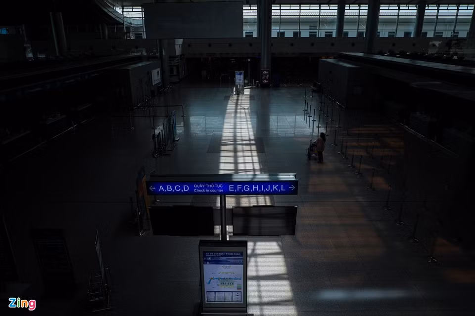 Khu vực làm thủ tục chỉ có một vài nhân viên sân bay qua lại.