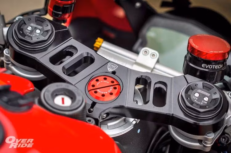 Ở trên khu vực tay lái, chiếc xe đã được thay chảng 3 nhôm CNC từ hãng CNC Racing cùng với trợ lực Ohlins và cặp bình dầu Evotech. Lùi xuống dưới một chút là nắp bình xăng đóng mở nhanh theo phong cách xe đua.