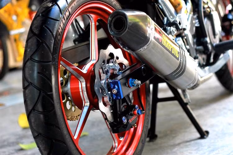 Đĩa hoa kiểng và heo Brembo pát ngược giúp hoàn thành hệ thống phanh. Bánh sau vẫn sử dụng mâm CNC cùng cặp lốp Michelin Sporty. Cây pô Akrapovic giúp "phô diễn" âm thành trầm đặc trưng của khối động cơ DOHC 150 cc trên Satria F150 một cách ấn tượng nhất.