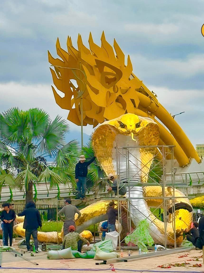 Chất liệu thi công gồm khung sắt bên trong, chất liệu chính là xốp, phần vẩy rắn đắp vật liệu tạo độ chân thật, mềm mại và màu sắc vàng óng ánh, như được bao phủ một lớp áo giáp vàng.