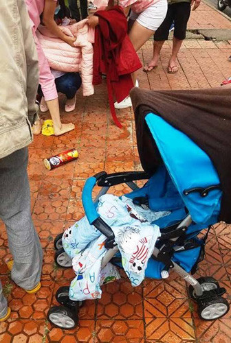 Cháu bé và chiếc xe khi vừa được vớt lên khỏi hồ nước