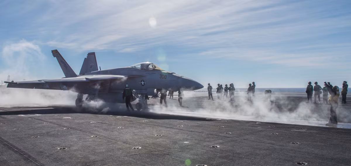 Hệ thống phóng "bốc khói" sau pha cất cánh của chiếc tiêm kích trước còn chưa kịp nguội đã sẵn sàng cho chiếc thứ hai vào vị trí. Đường băng trên tàu sân bay hoạt động liên tục bất kể ngày đêm với rất nhiều bài bay huấn luyện trong nhiều điều kiện thời tiết cung cấp cho các phi công trên tàu sân bay một lượng giờ bay đáng kinh ngạc. Nguồn ảnh: Militarynews.