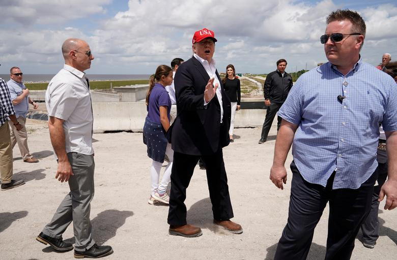 Tổng thống Trump nói chuyện với các phóng viên trong khi các nhân viên Mật vụ Mỹ đứng bảo vệ xung quanh tại Canal Point, Florida, Mỹ, ngày 29/3/2019.