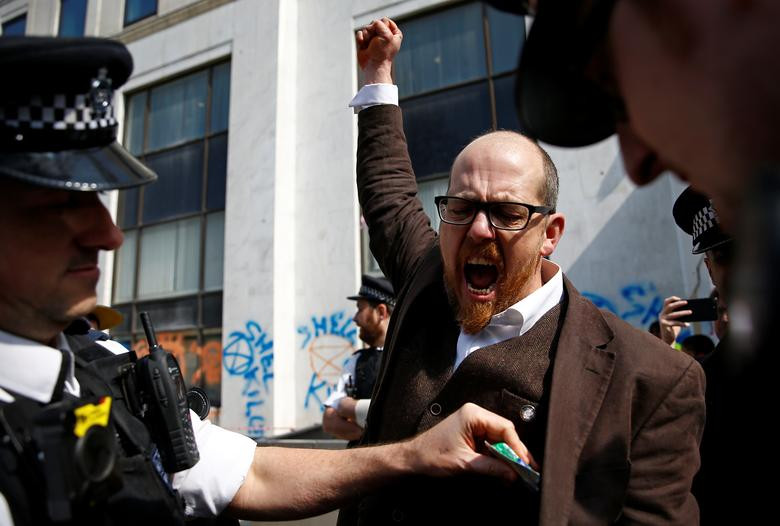 Một nhà hoạt động chống biến đổi khí hậu hô to khi bị cảnh sát bắt giữ tại London ngày 15/4.