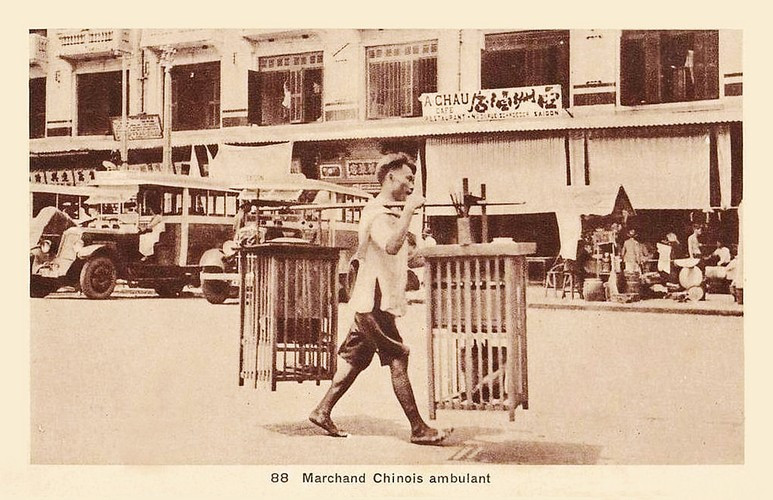 Người bán tàu hủ rong đi qua đường Schroder, nay là đường Phan Châu Trinh phía bên trái chợ Bến Thành, Sài Gòn một thế kỷ trước. Ảnh: Public Domain.