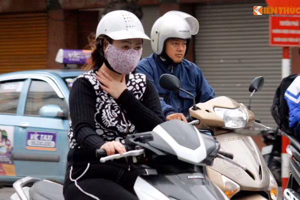 Gió lạnh lùa vào cổ khiến người phụ nữ cảm thấy khó chịu khi tham gia giao thông.