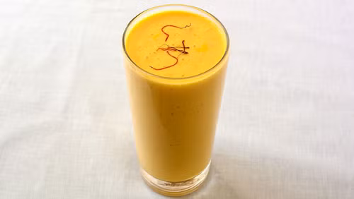 4. Sinh tố xoài. Sinh tố xoài là một dạng Lassi, nguyên liệu chính là sữa chua và xoài tươi. Ngoài ra, người bán còn thêm bạch đậu khấu, nước và đường để tạo hương vị riêng biệt. Cũng giống những món đồ uống khác của Ấn Độ, sinh tố xoài được pha chế thành thức uống có dạng kem và sủi bọt mới "đạt chuẩn".