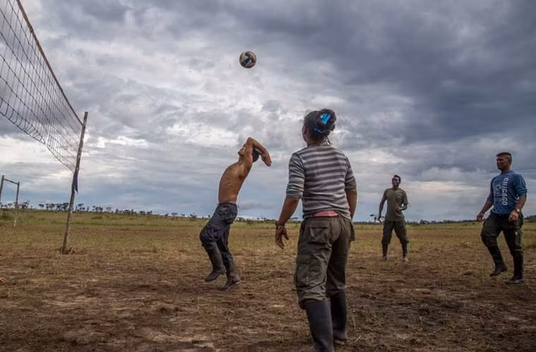 Các thành viên nhóm du kích FARC cùng người dân chơi bóng chuyền.