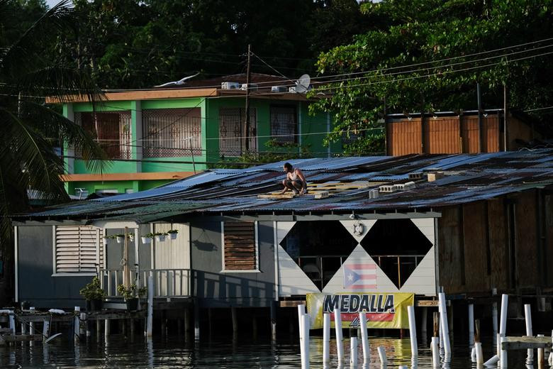 Người dân sửa chữa mái nhà ở Cabo Rojo trước khi cơn bão mạnh ập tới hôm 27/8.