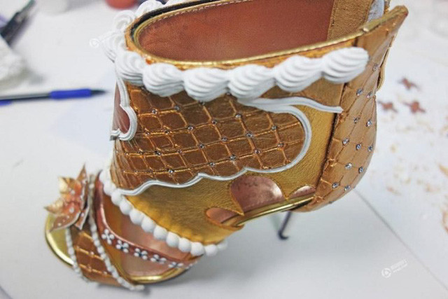 Đôi giày gồm một viên kim cương hồng 3 cara, 1 viên xanh nước biển 1 cara, (trị giá hơn 128.000 USD), cùng 4 viên kim cương 3 cara và bộ kim cương 1.000 viên bọc bạch kim sắp xếp trên các chi tiết, tạo hình một chiếc bánh. Ảnh: Odditycentral.