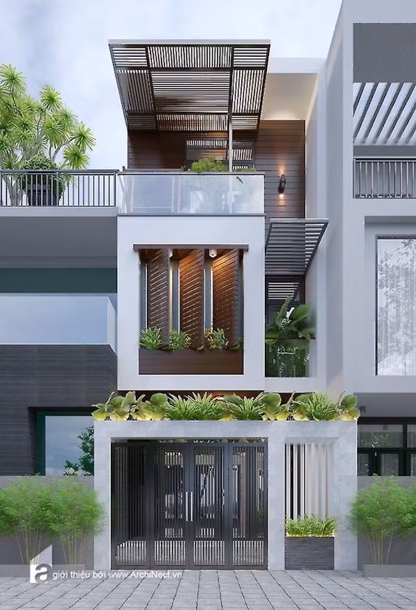 Nhà 3 tầng nổi bật với gàm màu trắng sáng và hệ lam chắn trên sân thượng. Ảnh: Kientrucsuvietnam.