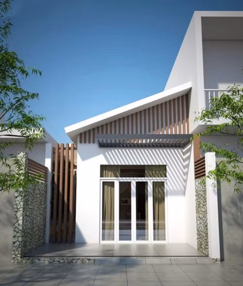 Mái lệch giúp che đi phần mái tôn của căn nhà mà vẫn mang lại nét đẹp sang trọng. Ảnh: Vtkong.