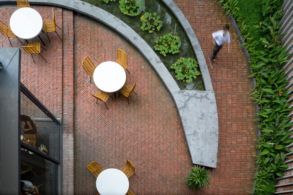 Lối vào nhà hàng pizza có sân nhỏ hình oval, giúp tối đa hóa tầm nhìn phong cảnh của khách.