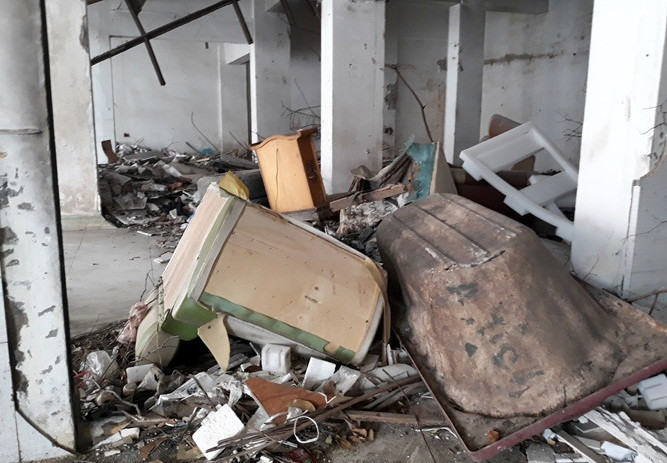 Nền nhà la liệt rác thải sinh hoạt, đồ đạc cũ như bàn ghế, bồn cầu cũ hỏng. Ảnh: Bảo Ngọc.