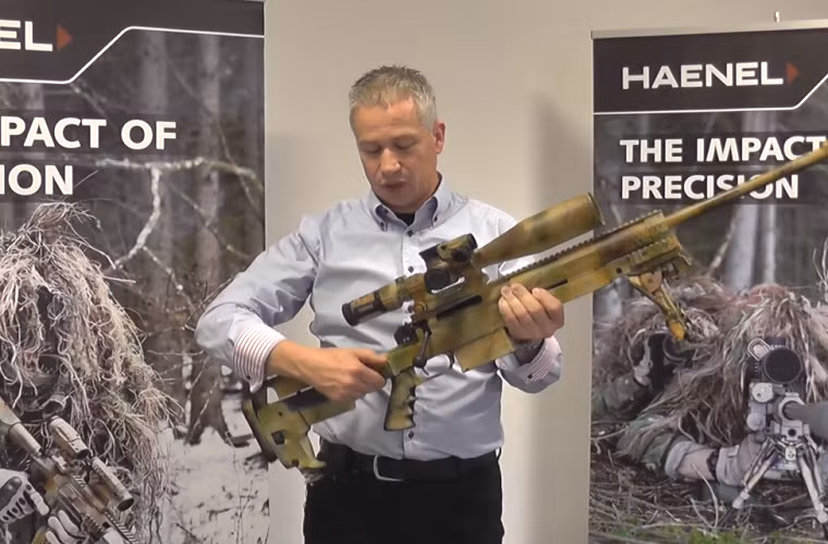 Được biết CG Haenel là một trong những công ty con của tập đoàn Merkel Gruppe của Đức tuy nhiên tập đoàn này lại thuộc quyền sở hữu của một tập đoàn khác có tên Tawazun có trụ sở chính ở Abu Dhabi, UAE.