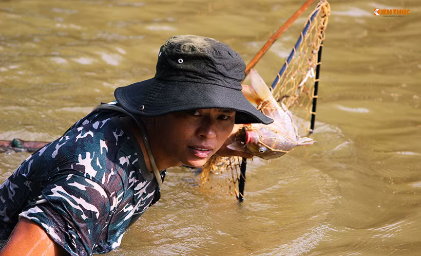 Người đàn ông may mắn bắt được thêm một con cá chép, và nhanh chóng di chuyển vào phía bờ.