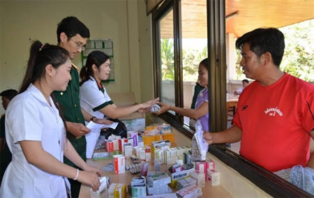 Thời tiết cao nguyên Bô-lô-ven thuộc các tỉnh phía Nam của Lào đang mùa lạnh, những bản làng, con đường xuyên rừng hun hút đầy bụi đỏ, đến nơi nào, công tác tổ chức, triển khai khám bệnh được thực hiện nhanh chóng, chặt chẽ, nhiệt tình, để lại những cảm xúc sâu đậm, ấm áp nghĩa tình hữu nghị truyền thống, đoàn kết đặc biệt Việt - Lào. Đoàn đã tổ chức khám bệnh cho hơn 500 cán bộ, chiến sĩ các đơn vị quân đội, nhân dân các huyện Pắc-xoòng, thành phố Pắc-xê thuộc tỉnh Chăm-pa-sắc. Ảnh: Cấp thuốc miễn phí cho người nghèo sau khi khám bệnh tại Bệnh viện tỉnh Chăm-pa-sắc.