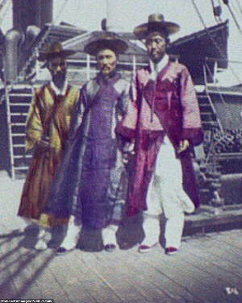 Ba người đàn ông quý tộc đứng trên boong của một con tàu đang chuẩn bị khởi hành.