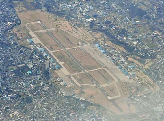 Căn cứ quân sự mới trên đảo Mage được cho là sẽ làm giảm bớt gánh nặng tại căn cứ huấn luyện không quân trên hàng không mẫu hạm của Hoa Kỳ mang tên Atsugi ở tỉnh Kanagawa. Đây được cho là một sự bất tiện vô cùng lớn khi tần suất hạ cánh của máy bay quân sự Mỹ là vô cùng thường xuyên trong khi căn cứ lại quá gần khu đông dân cư, chỉ cách sân bay Haneda của Tokyo 33km, khiến người dân sống xung quanh vô cùng khó chịu. Hơn nữa, nó lại nằm quá sâu trong nội địa Nhật Bản, điều này là khó mô phỏng thực tế cất hạ cánh máy bay trên biển. Ảnh: Căn cứ huấn luyện không quân Atsugi tại Kanagawa.