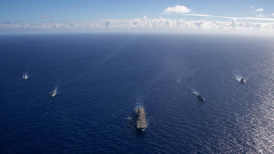 Các quốc gia cử lực lượng tàu đến tham gia RIMPAC 2020 bao gồm: Australia, Brunei, Canada, Pháp, Nhật Bản, New Zealand, Hàn Quốc, Philippines, Singapore cùng với các tàu của chủ nhà Mỹ. Với sự góp mặt của hàng không mẫu hạm USS Carl Vinson lớp Nimizt của hải quân Mỹ làm tàu dẫn đầu nhóm tác chiến cùng sự phối thuộc của biên đội tiêm kích hạm F/A-18. Ảnh: Biên đội tàu hải quân quốc tế trong khuôn khổ tập trận RIMPAC 2020, ở giữa là tàu đổ bộ tấn công USS Essex (LHD-2) của hải quân Mỹ.