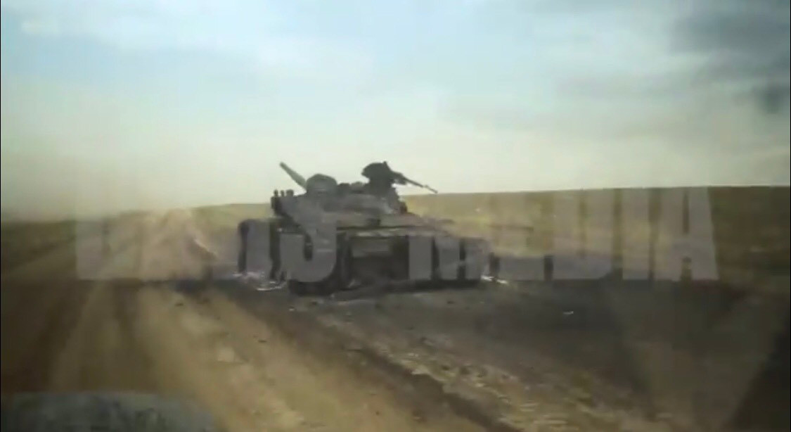 Tuy nhiên ở góc quay khác ta có thể nhanh chóng nhận ra đây không phải T-90S mà là xe tăng chiến đấu chủ lực T-72 Aslan nâng cấp với đặc trưng là cụm ống phóng lựu đạn khói chỉ đặt ở bên trái tháp pháo, tháp pháo tròn khác với tháp pháo vuông của T-90 và súng máy 12.7mm vẫn điều khiển thủ công lộ thiên bởi trưởng xa chứ không điều khiển được từ bên trong như T-90. Ảnh: Chiếc xe tăng bị nghi ngờ là T-90S thực ra là T-72 Aslan.