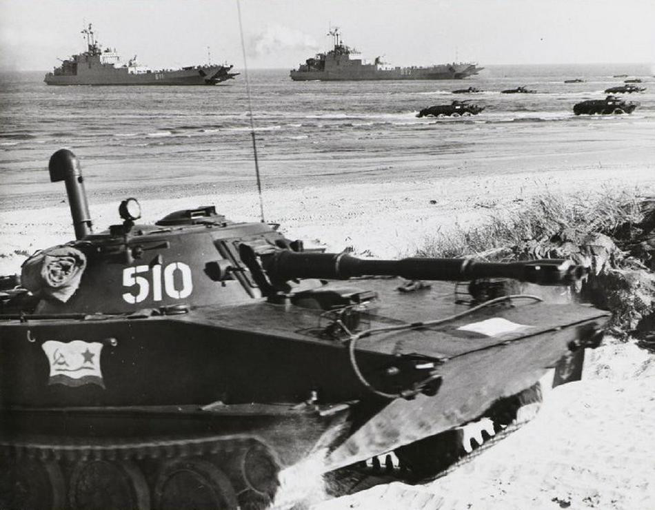 Đã 40 năm kể từ khi cuộc tập trận đổ bộ lên bãi biển của Đông Đức diễn ra, cộng với đó là sự tan rã của khối Waszawa cũng như Liên Xô sụp đổ, tuy nhiên những kí ước oai hùng về một thời là một tổ chức quân sự vô cùng mạnh mẽ, đủ sức làm đối thủ của NATO vẫn còn in dấu ấn đậm nét. Ngày nay, rất nhiều quốc gia thuộc khối Waszawa cũ đã quay lại gia nhập chính NATO, tuy nhiên đâu đó trong quân đội của họ vẫn còn giữ những nét ảnh hưởng rất riêng của Liên Xô. Ảnh: Xe tăng PT-76 của Hải quân đánh bộ Liên Xô, phía xa là đội hình xe bọc thép đổ bộ từ tàu há mồm.