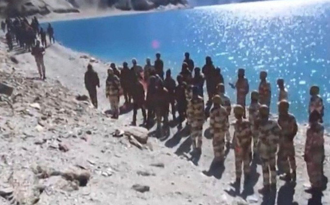 Tình hình căng thẳng biên giới Trung Quốc và Ấn Độ đã diễn ra từ tháng 4 tại khu vực Ladakh, tuy nhiên các bên vẫn chỉ mới dừng lại ở mức độ xô xát bằng gậy gộc và gạch đá, cùng đấu tranh bằng băng rôn và biểu ngữ. Ảnh: Binh sĩ Ấn Độ (gần) và binh sĩ Trung Quốc (xa) tại khu vực tranh chấp.