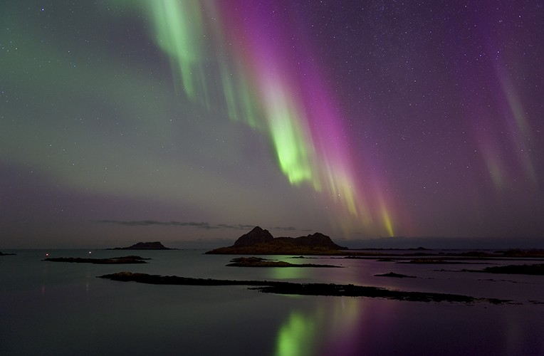 Kết quả là cực quang phát ra ánh sáng hồng cẩm cực hiếm gặp khi các hạt tích điện đập vào các nguyên tử nitơ.